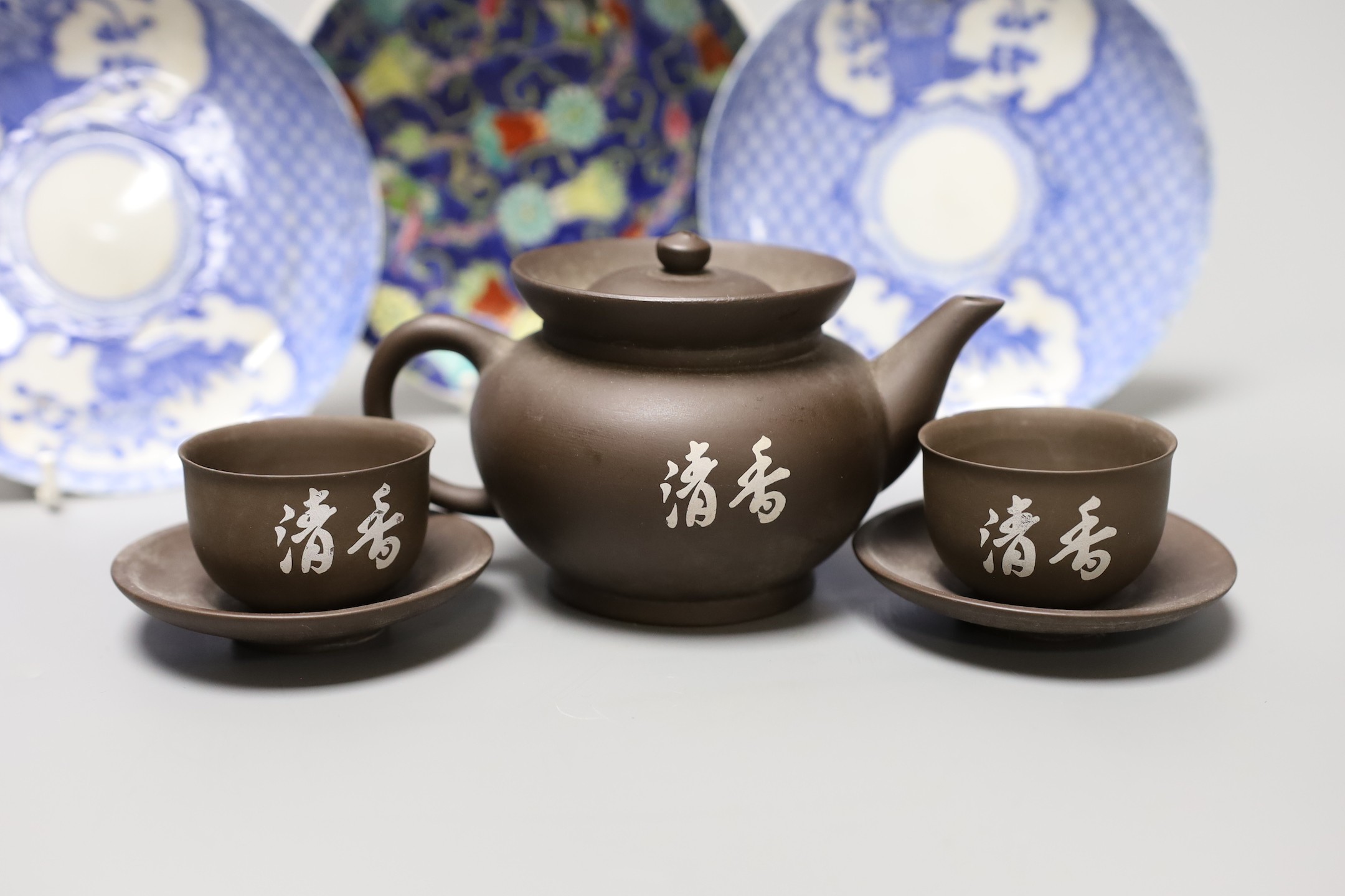 A selection of Oriental items, to include blue and white Japanese saucers, two stoneware tea bowls, a Chinese blue and white paste box and cover, and a Yixing teapot and a pair of tea bowls